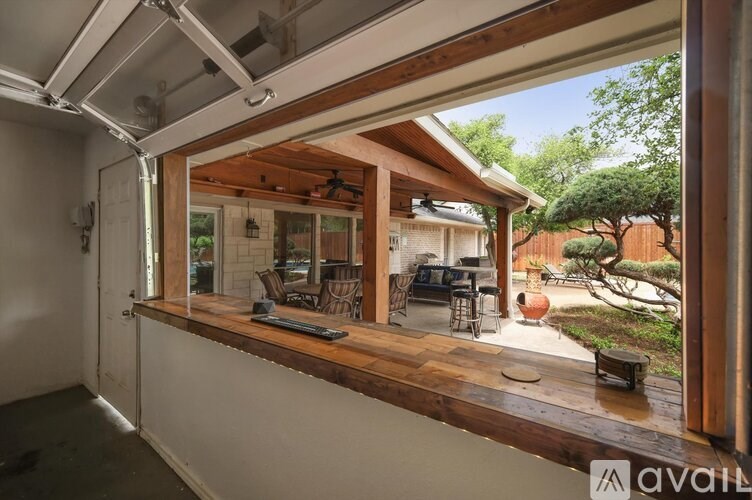 A sunroom with a view of a backyard.