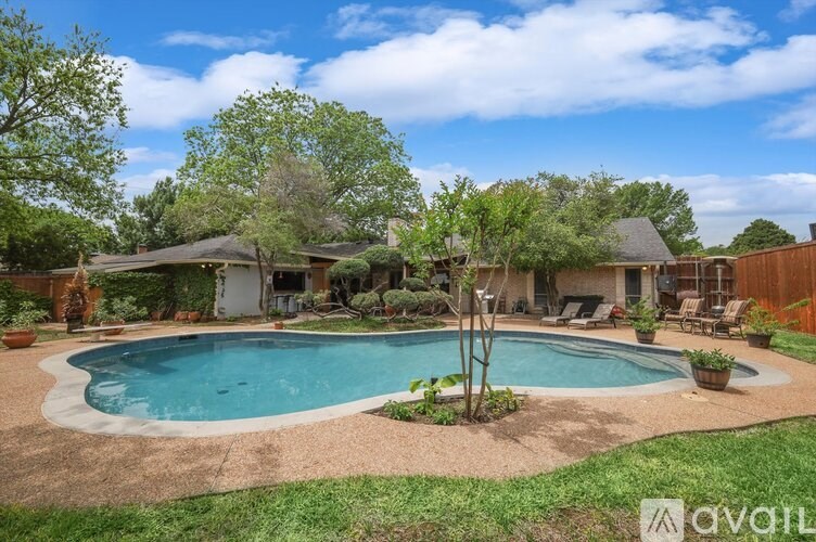 A backyard with a pool and a patio area.