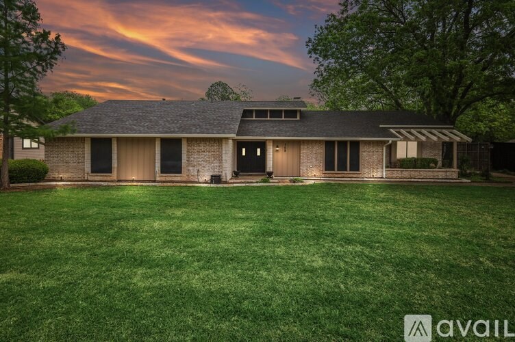 A house with a large lawn is available for sale.