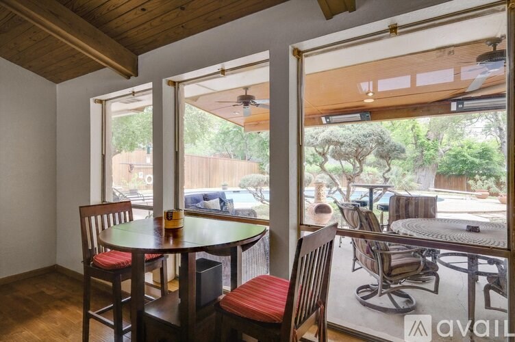 A dining area with a table and chairs is shown.