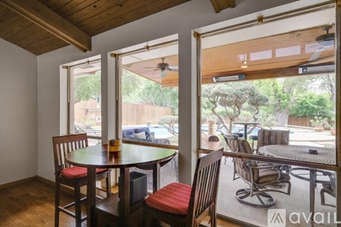 A dining area with a table and chairs is shown.