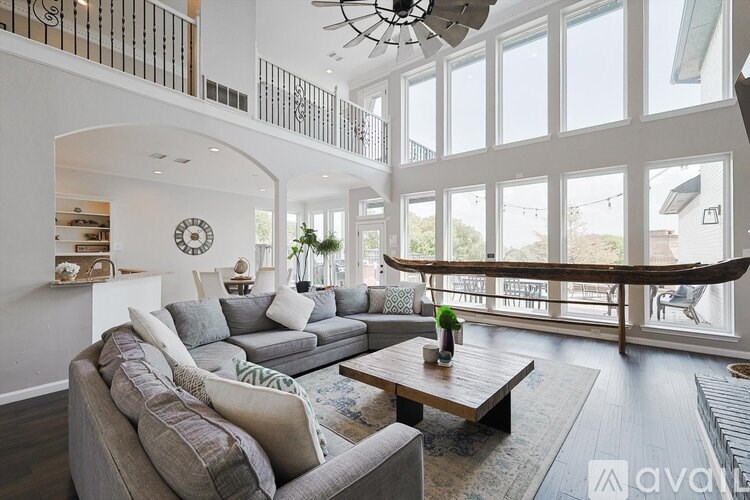 A living room with a grey couch and a wooden coffee table.