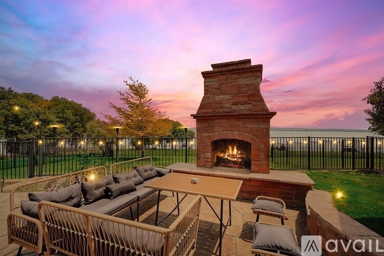 A backyard with a fireplace and seating area.