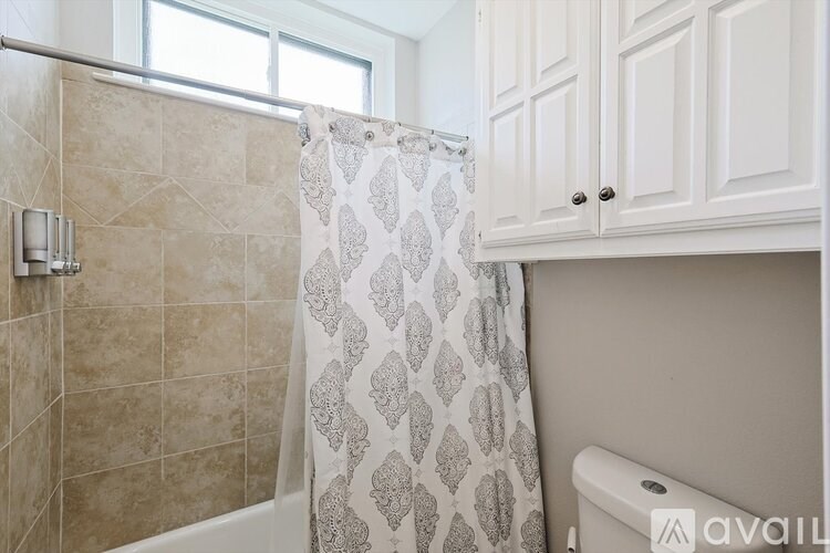 A bathroom with a tiled shower and a toilet.
