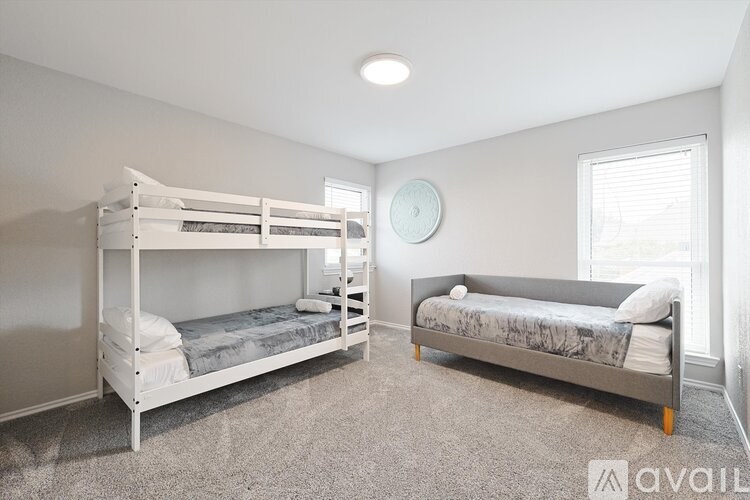 A bedroom with a bunk bed and a single bed.