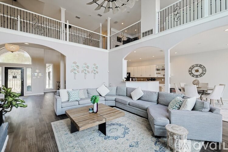 A spacious living room with a large couch and a coffee table.