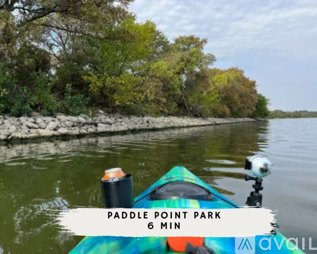 A kayak is on a river with Paddle Point Park written on the side.