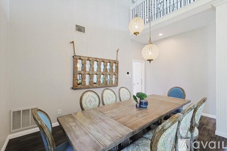 A dining room with a wooden table and chairs.