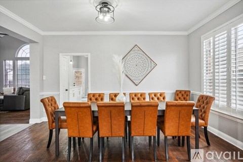 A dining room with a table set for six.