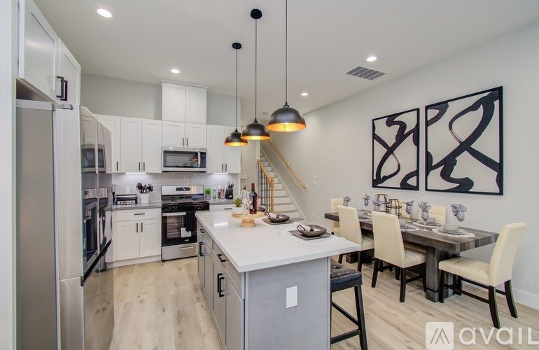 A modern kitchen with a dining table and chairs.