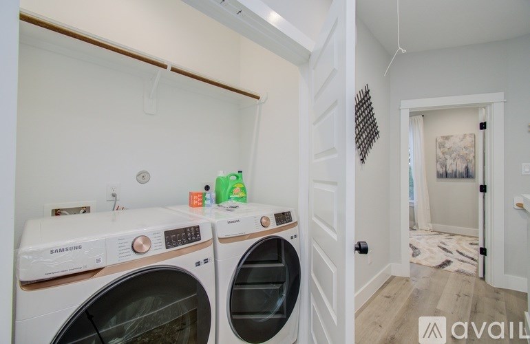 A laundry room with two front-loading washing machines.