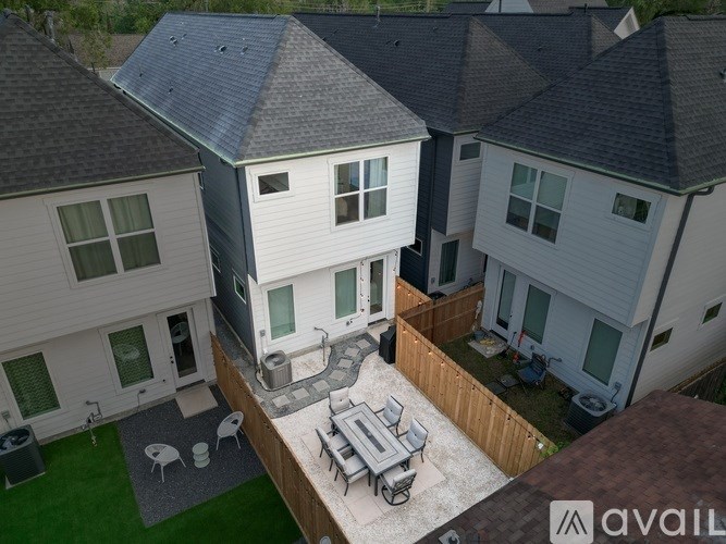 A bird's eye view of a house with a patio and a backyard.