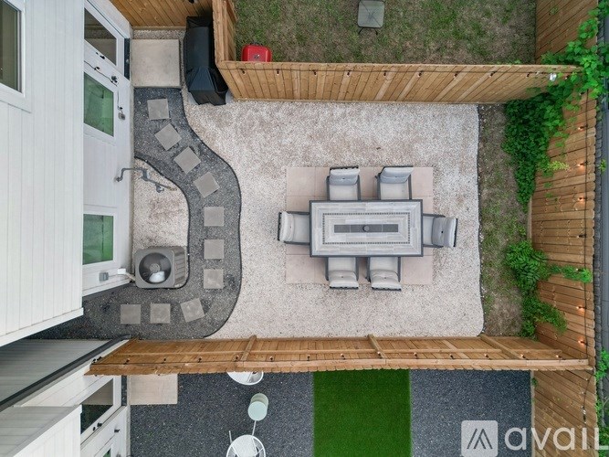A small outdoor kitchen area with a grill and sink.