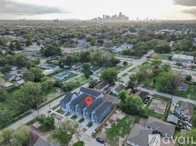 A bird's eye view of a residential area with a blue house marked with a red pin.