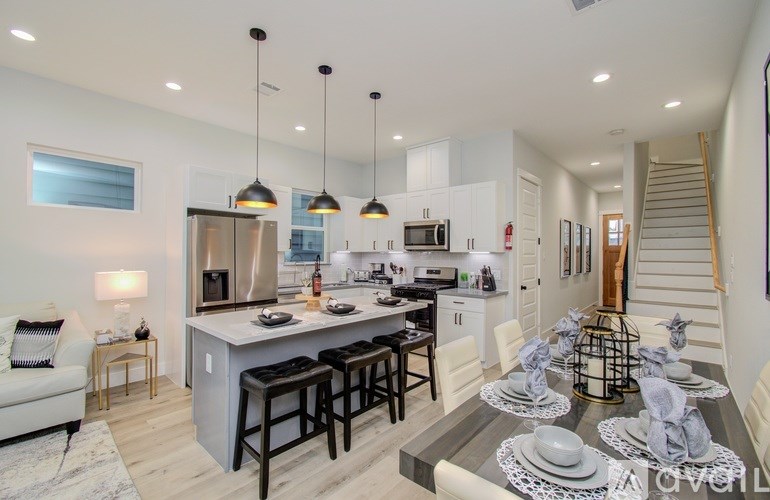 A modern kitchen with a dining table set for four.