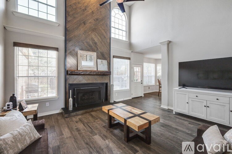 A living room with a fireplace and a television.