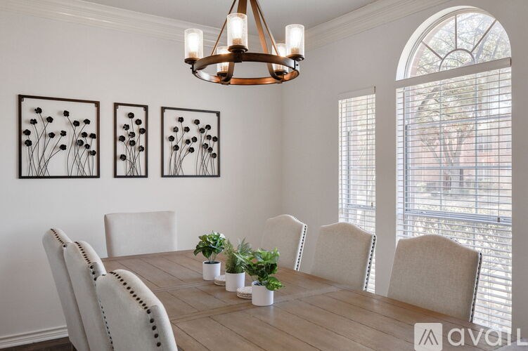 A dining room with a wooden table and chairs.