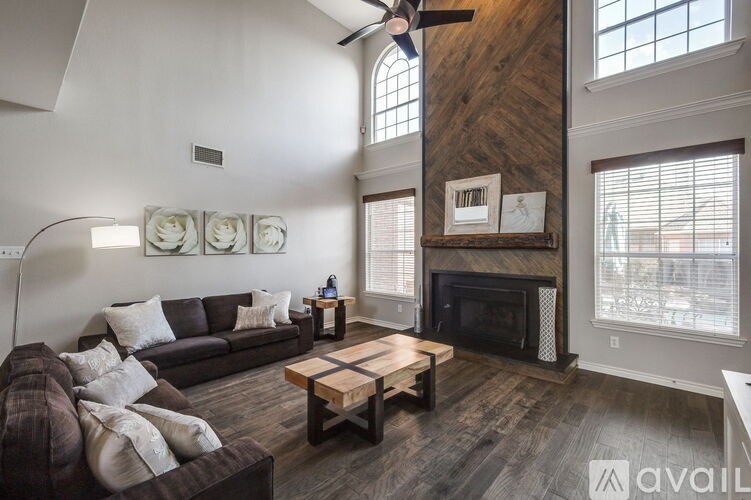 A living room with a brown couch and a wooden coffee table.