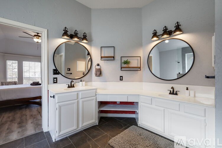 A bathroom with two sinks and two mirrors.