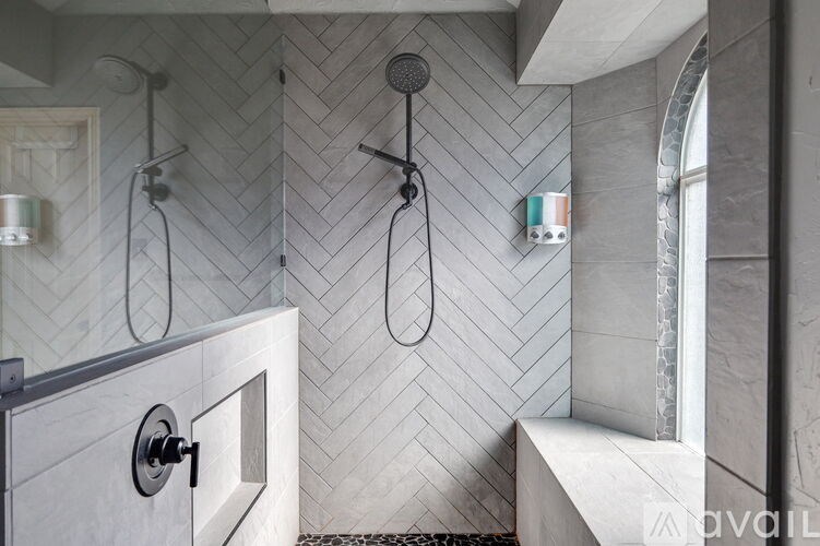 A bathroom with a shower and a bench.