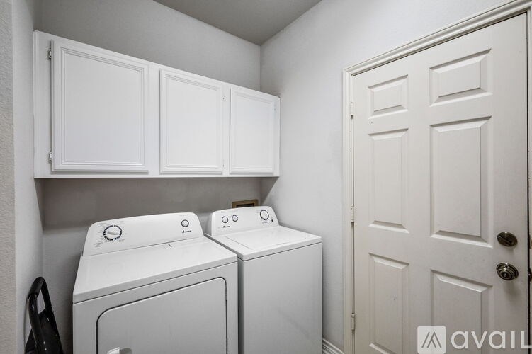 A white washing machine and dryer in a small laundry room.