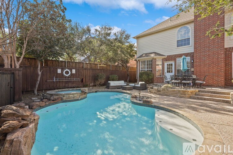 A backyard with a pool and a house.