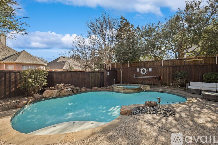 A backyard with a pool and a fence.