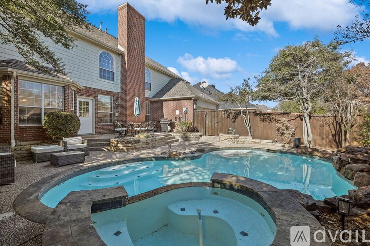 A backyard with a pool and a house.