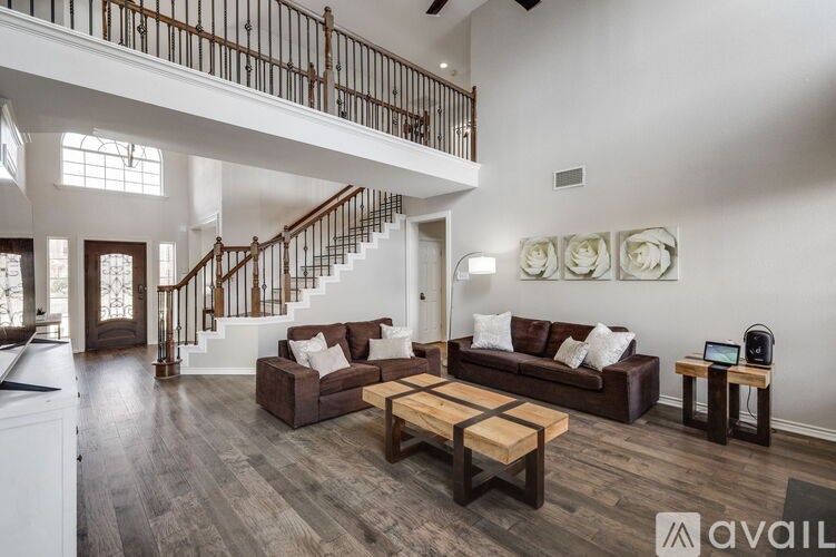 A living room with a staircase and a couch.