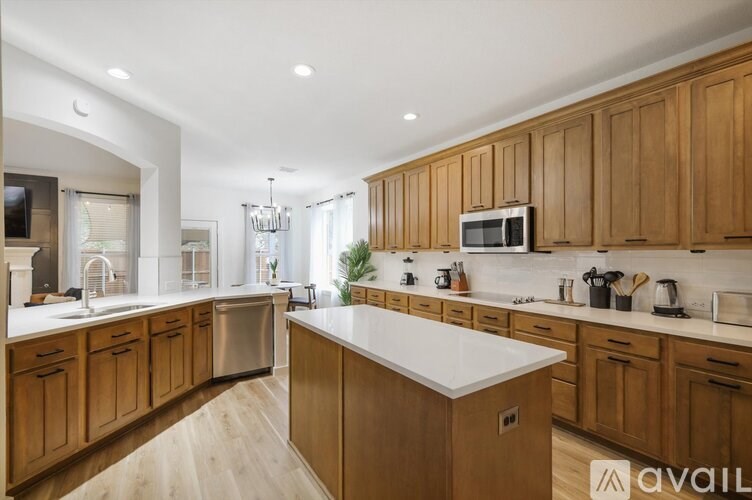 A modern kitchen with wooden cabinets and a white countertop.