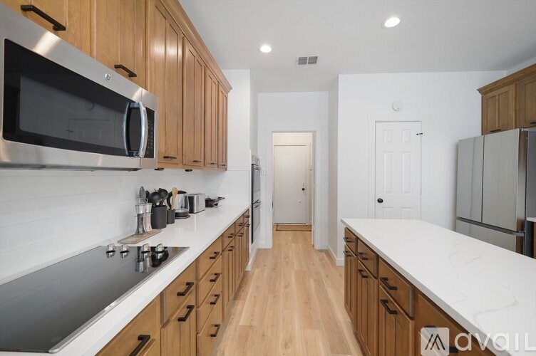A kitchen with wooden cabinets and a white countertop.