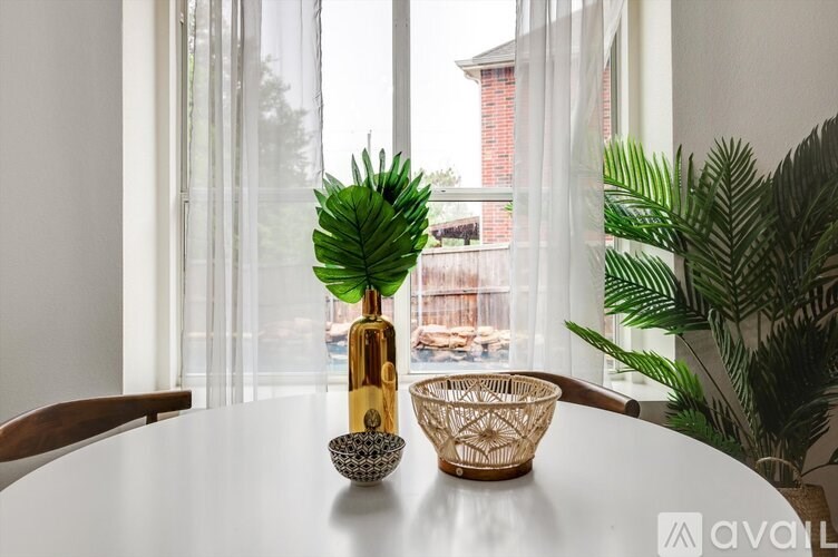 A table with a vase and a bowl on it.
