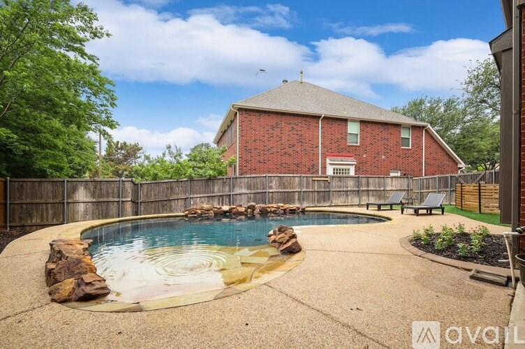 A backyard with a pool and a house.