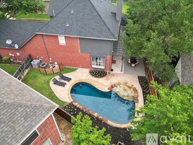 A backyard with a pool and a deck.