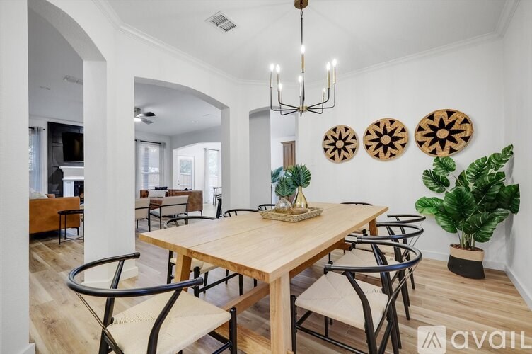 A dining room with a wooden table and chairs.