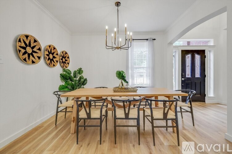 A dining room with a wooden table and chairs.