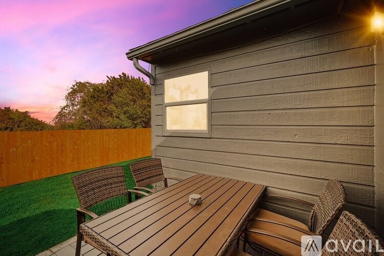A wooden table is set outside on a patio.