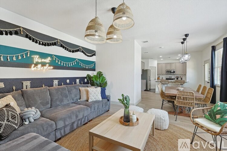 A living room with a grey couch and a wooden coffee table.