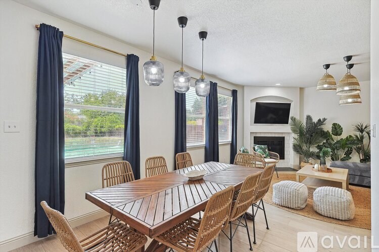 A dining room with a wooden table and chairs.