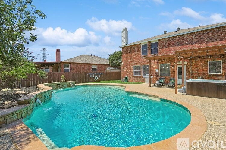 A backyard with a pool and a house.