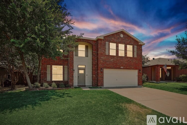 A house with a garage and a driveway is available for sale.