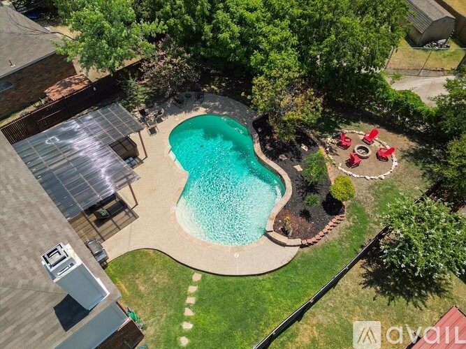 A backyard with a kidney-shaped pool and a hot tub.