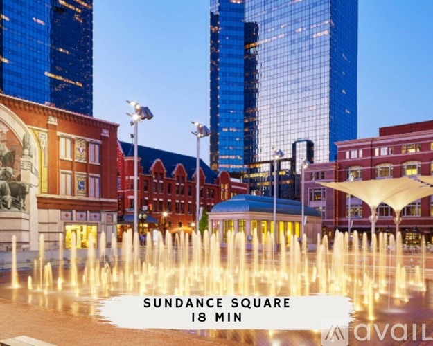 A fountain in the middle of a city square with the text "SUNDANCE SQUARE 18 MIN".