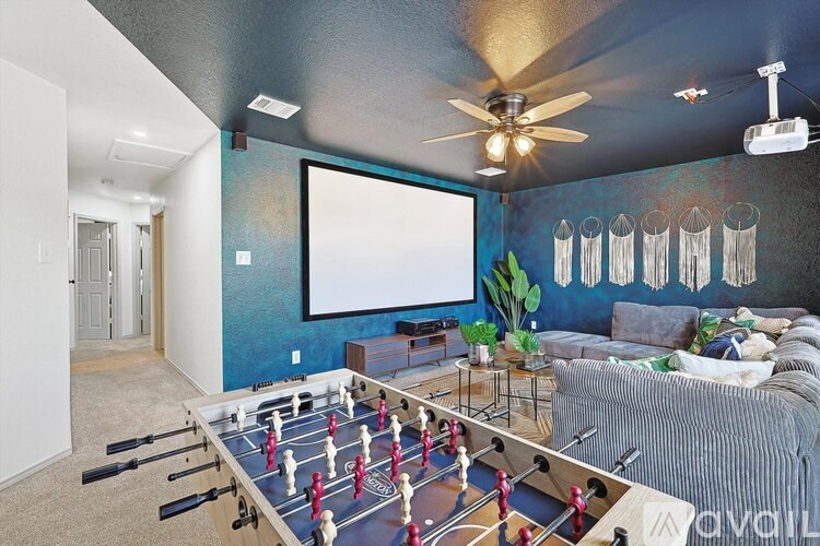 A foosball table is in the middle of a living room.