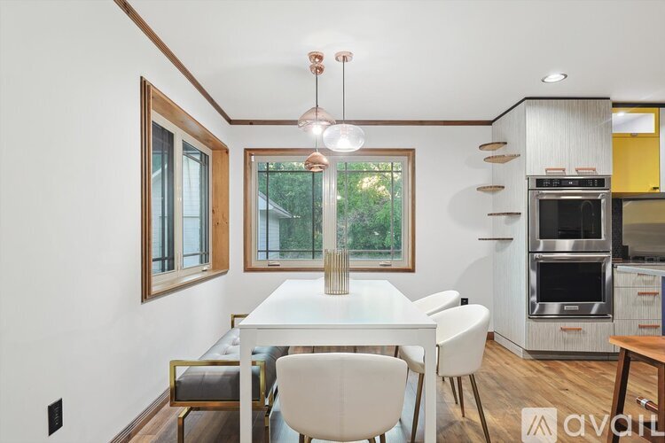 A modern kitchen with a dining table and chairs.