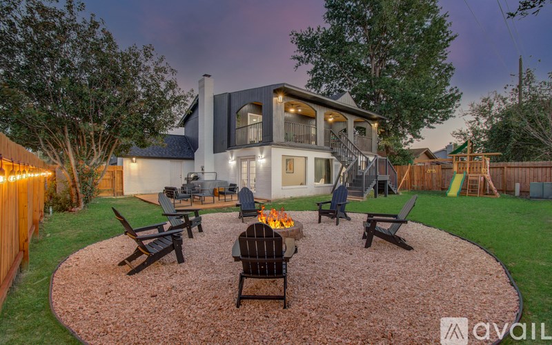 A house with a patio and a fire pit in the backyard.