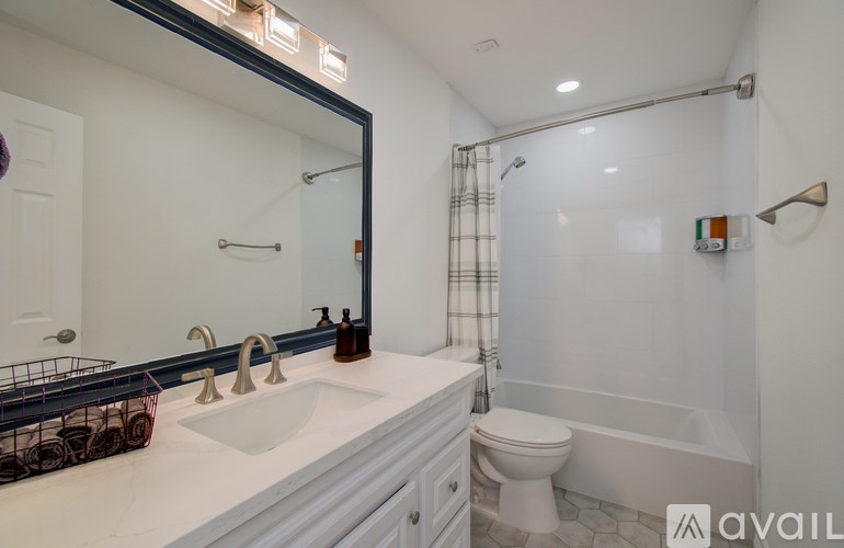 A bathroom with a white sink and a white toilet.