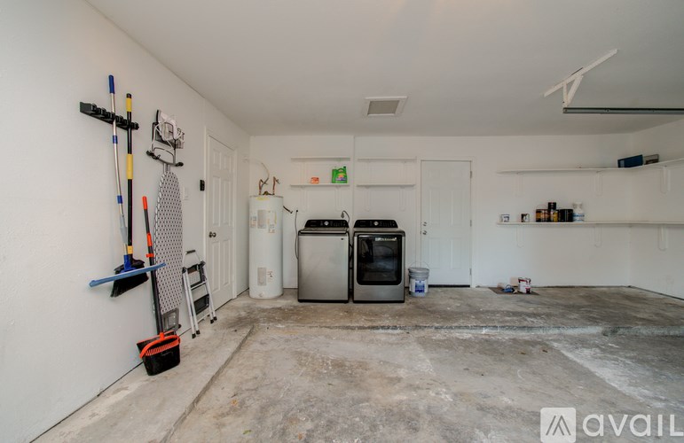 A room with white walls and a concrete floor is being prepared for renovation.