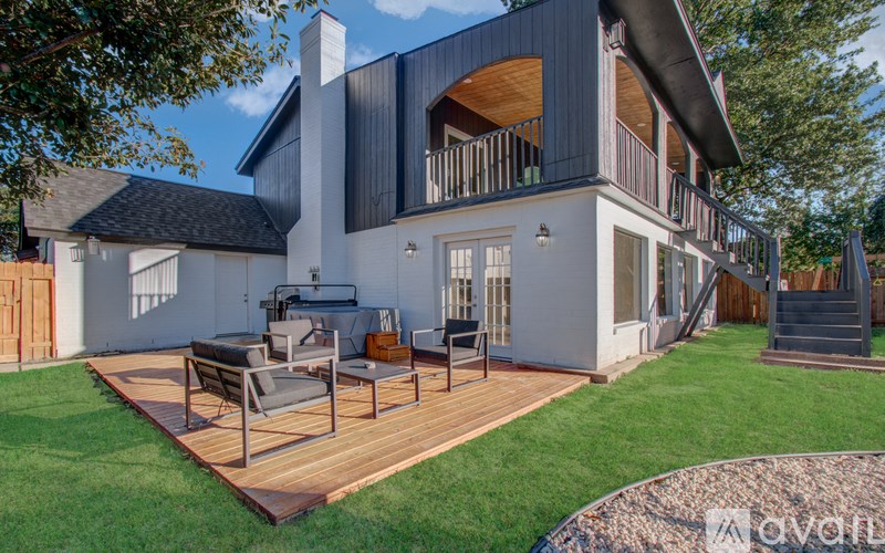 A modern house with a large deck and patio area.