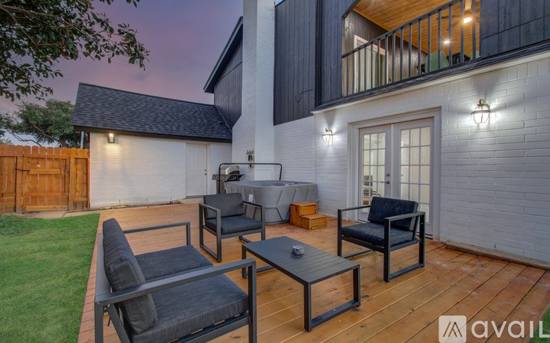 A patio with a table and chairs is set up outside a house.